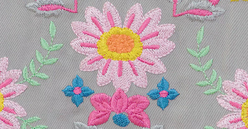 Floral embroidery on a grey fabric