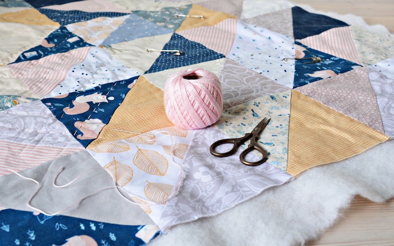 the process of sewing a quilt blanket