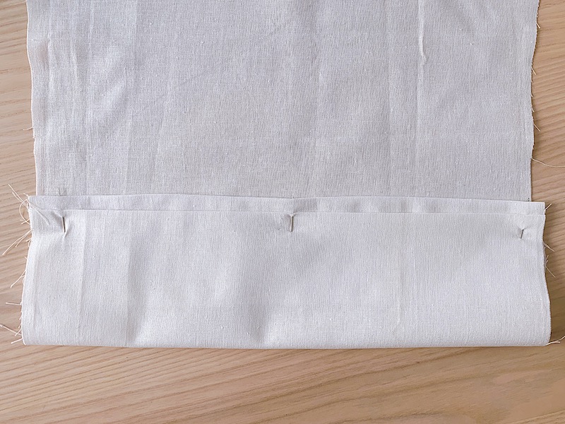 a white piece of fabric folded along the hemline