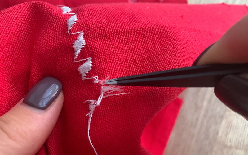 removing embroidery from a red piece of fabric