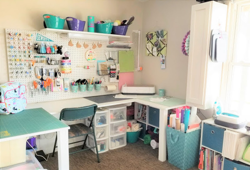 sewing room with tables, chair and peg board