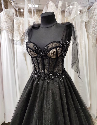 black corset dress on a dress form