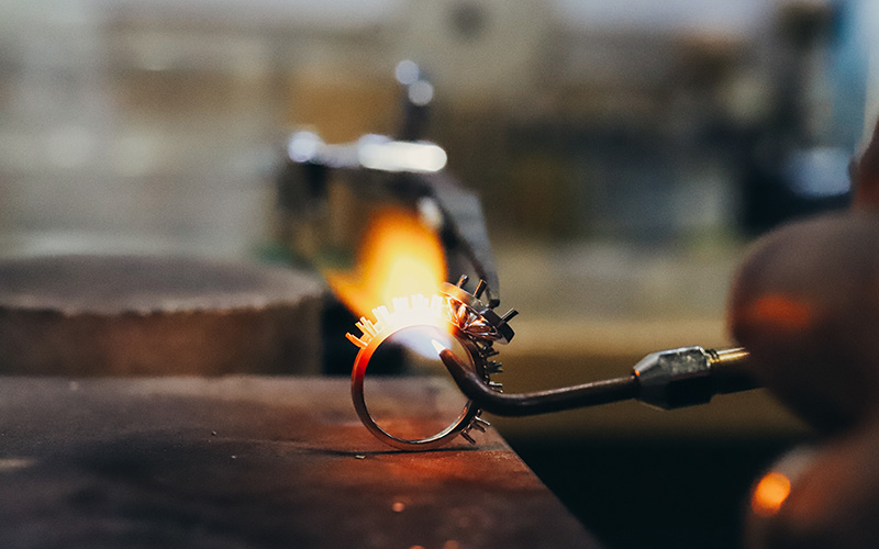 ring with a flame against it during the craftsmanship process